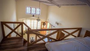 a bedroom with a wooden bed and a stairway at The Realm in Coonoor