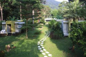 a garden with a pathway leading to a house at Lazy Republique in Ko Chang