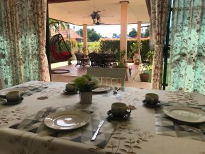 a table with plates and utensils on top of it at Mae Phim, Rayong, Bali Residence Villa in Mae Pim