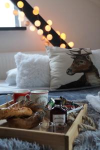 a tray of food on a table with a deer on a couch at Feliciana in the heart of Old Town with Wawel's view in Kraków