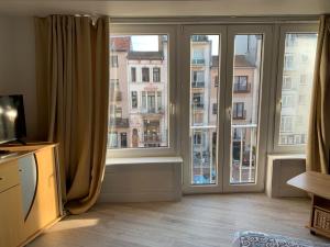 a room with a large window with a view of a building at Studio Mare Nostrum in Blankenberge