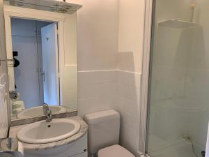 a bathroom with a toilet and a sink and a shower at Studio Mare Nostrum in Blankenberge