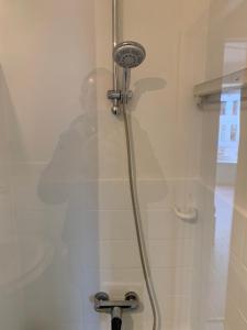 a shower in a bathroom with a shower head at Studio Mare Nostrum in Blankenberge