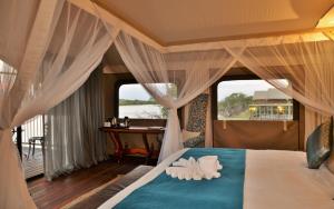 A bed or beds in a room at Jackalberry Chobe