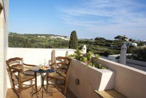 a patio with a table and chairs on a balcony at Celestia Traditional Houses in Keramoto