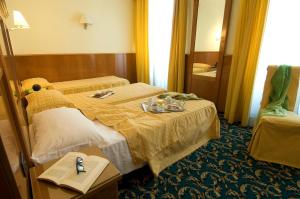 a hotel room with a bed with a tray of food on it at Hotel Cinque Giornate in Milan