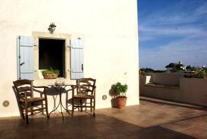 a patio with a table and chairs on a balcony at Celestia Traditional Houses in Keramoto