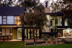 a modern house with a lot of windows at Middelwater Farm Hotel in Bloemfontein