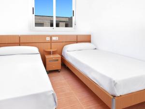 Postel nebo postele na pokoji v ubytování APCOSTAS Torremar - Oropesa