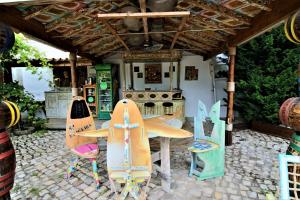 a patio with a table and chairs in front of a kitchen at Villa Ana Margarida by Nature in Ericeira