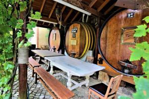 a room with two tables and two wine barrels at Villa Ana Margarida by Nature in Ericeira