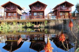 a resort with a reflection in the water at Villa Ana Margarida by Nature in Ericeira +3 photos