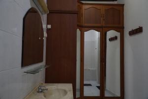 a bathroom with a sink and a mirror at Omah Pelem Yogya in Yogyakarta