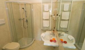 a bathroom with a sink and a shower and a toilet at Hotel Cinque Giornate in Milan