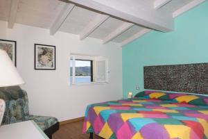 A bed or beds in a room at Appartamenti Lungomare Seafront - Goelba