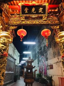 a building with chinese decorations and a clock in a room at Phuket Sunny Hostel in Phuket Town