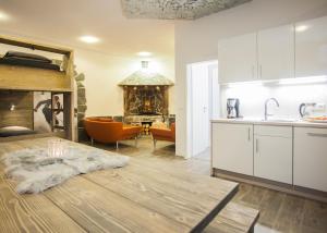 a kitchen and living room with a table and a fireplace at Piste und Pedale , Deine Bude-Dein Abenteuer in Winterberg