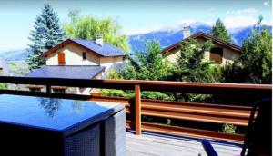 a balcony with a view of a house at Résidence Campredon - 6 à 8 pers - Terrasse 25m2 plein sud - Jardin - Internet - Parking - Navette pied du logement - Linge Inclus - Ménage en option in Font-Romeu