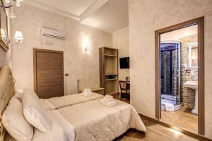 a hotel room with a bed and a television at AMICI GUESTHOUSE in Rome