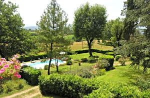 a swimming pool in a garden with trees and flowers at Il Villino in Rabatta