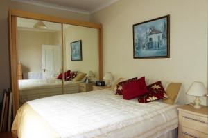 a bedroom with two beds and a large mirror at Skene Terrace Apartments in Aberdeen