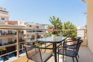 a balcony with a table and chairs on a balcony at Mary Suites Chania in Chania Town