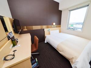 Postel nebo postele na pokoji v ubytování Super Hotel JR Nara Ekimae Sanjo Dori