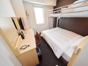 Postel nebo postele na pokoji v ubytování Super Hotel JR Nara Ekimae Sanjo Dori