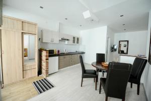 a kitchen and dining room with a table and chairs at Apartment Citta Vecchia in Mostar