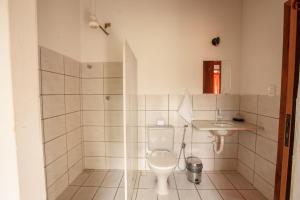 a bathroom with a toilet and a sink at Pousada Casa de Jorge in Lençóis
