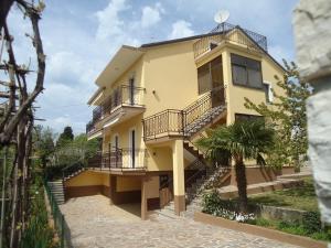 a yellow house with stairs in front of it at Mariella in Bašanija