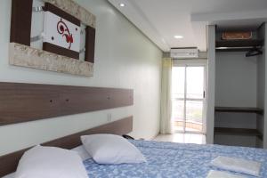 a bedroom with a bed with two pillows at Hotel Soldera Inn in Sertãozinho +29 photos