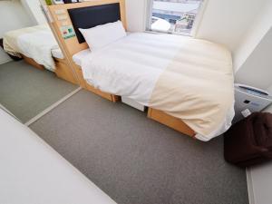 Postel nebo postele na pokoji v ubytování Super Hotel JR Nara Ekimae Sanjo Dori