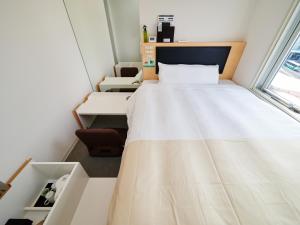 Postel nebo postele na pokoji v ubytování Super Hotel JR Nara Ekimae Sanjo Dori