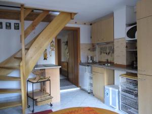 a kitchen with a staircase leading up to a loft at Ferienwohnung "Waldesruh" in Eibenstock