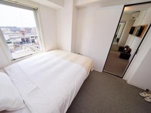 Postel nebo postele na pokoji v ubytování Super Hotel JR Nara Ekimae Sanjo Dori