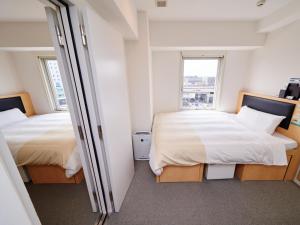 Postel nebo postele na pokoji v ubytování Super Hotel JR Nara Ekimae Sanjo Dori