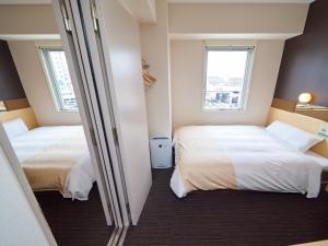 Postel nebo postele na pokoji v ubytování Super Hotel JR Nara Ekimae Sanjo Dori