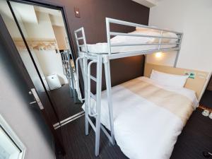 Postel nebo postele na pokoji v ubytování Super Hotel JR Nara Ekimae Sanjo Dori