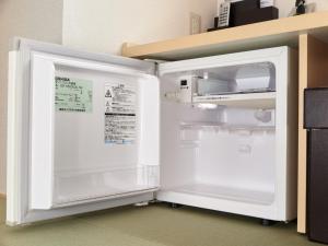 a refrigerator with its door open in a kitchen at Super Hotel JR Nara Ekimae Sanjo Dori in Nara