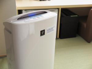 a white trash can sitting in front of a desk at Super Hotel JR Nara Ekimae Sanjo Dori in Nara