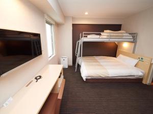 Postel nebo postele na pokoji v ubytování Super Hotel JR Nara Ekimae Sanjo Dori