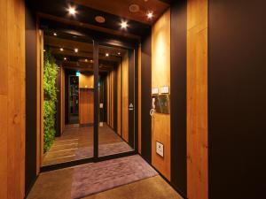 a hallway of a building with plants on the walls at Super Hotel JR Nara Ekimae Sanjo Dori in Nara