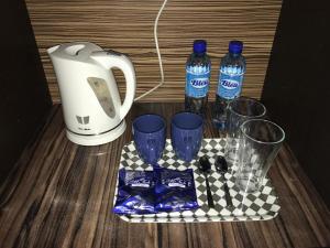 a tray with two bottles of water and some glasses at D'Faqih Studio @ Gold Coast Morib in Morib