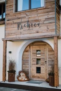 a building with a wooden door with a sign on it at Gästehaus Richter in Grainau