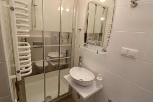 a bathroom with a sink and a glass shower at Villa SORENTO in Mielno +34 photos