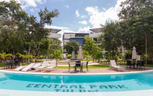 
a person standing in front of a swimming pool at Central Park Resort & Spa Tulum in Tulum
