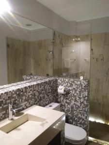 La salle de bains est pourvue d'un lavabo, de toilettes et d'un miroir. dans l'établissement Araucaria Hotel Boutique, à Valle de Bravo