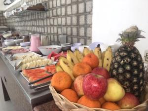 a buffet of fruits and vegetables on a table at Trópico Praia Hotel in Maceió