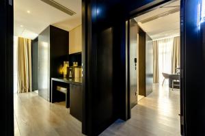 a kitchen with a refrigerator and a television at Hotel Santa Justa in Lisbon